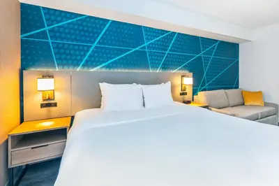 a hotel room with a bed and a couch at Comfort Suites in London