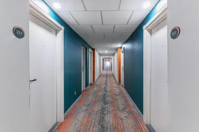 a corridor of an office building with blue walls at Comfort Suites in London