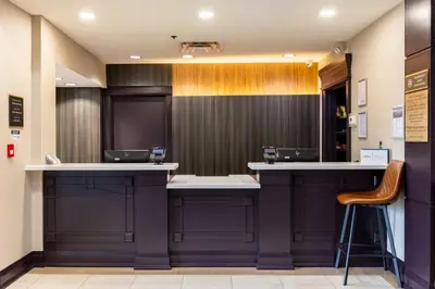 a bar in a waiting room with a chair at Staybridge Suites Guelph by IHG in Guelph