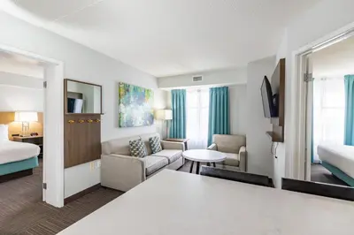 a hotel room with a bed and a living room at Staybridge Suites Guelph by IHG in Guelph