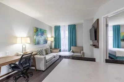a hotel room with a desk and a bed at Staybridge Suites Guelph by IHG in Guelph