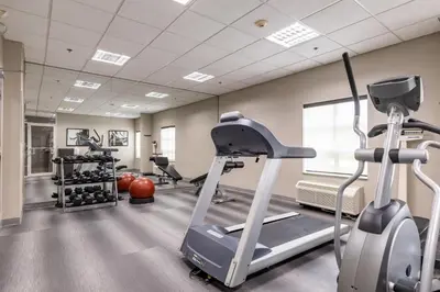 a gym with a treadmill and exercise bikes at Staybridge Suites Guelph by IHG in Guelph