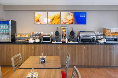 a dining room with a table and a counter with food at Comfort Inn in Orillia