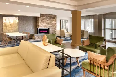 a living room with furniture and a fireplace at Fairfield Inn & Suites by Marriott Toronto Brampton in Brampton