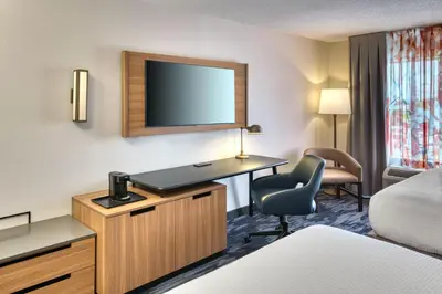 a hotel room with a desk and a tv at Fairfield Inn & Suites by Marriott Toronto Brampton in Brampton
