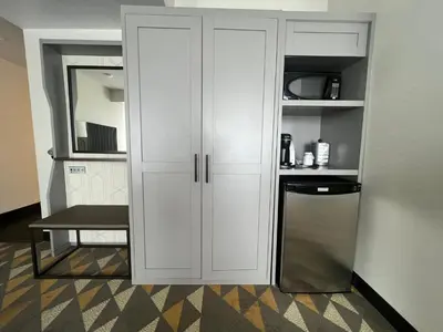 a kitchen with a white cabinet and a refrigerator at Holiday Inn Toronto Airport East by IHG in Toronto
