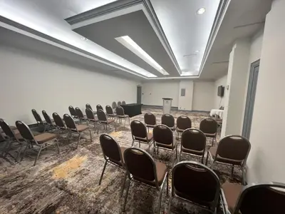 a room with rows of chairs and a projection screen at Holiday Inn Toronto Airport East by IHG in Toronto