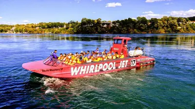 a group of people on a red boat in the water at The White House Boutique B&B in Niagara on the Lake