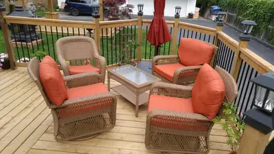 three chairs and a table on a deck at The White House Boutique B&B in Niagara on the Lake