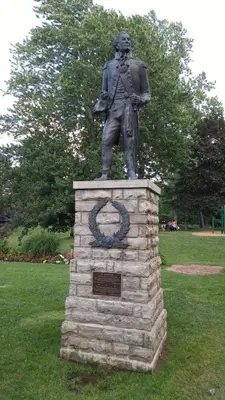 a statue of a man standing on top of a stone pillar at The White House Boutique B&B in Niagara on the Lake