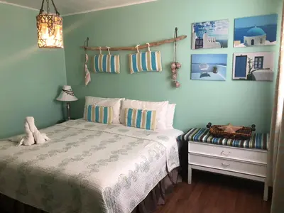a bedroom with a bed and a table with a lamp at The Rex Motel At Niagara Falls in Niagara Falls