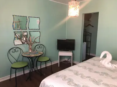 a bedroom with a bed and a table and chairs at The Rex Motel At Niagara Falls in Niagara Falls