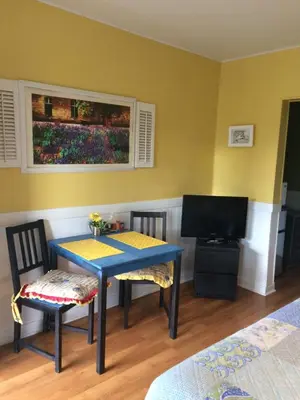 a room with a table and two chairs and a television at The Rex Motel At Niagara Falls in Niagara Falls