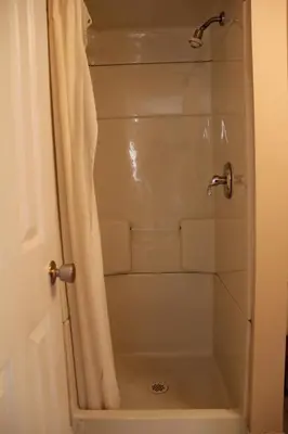a shower with a shower curtain in a bathroom at Niagara Inn & Suites in Niagara Falls