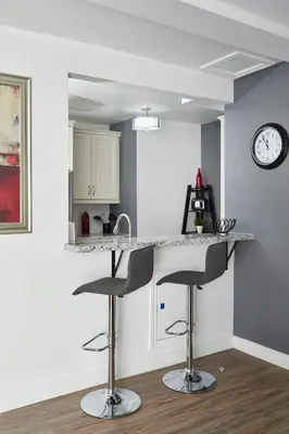 a kitchen with a counter and two bar stools at Vine Village in Niagara on the Lake