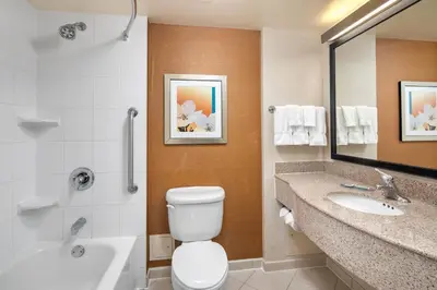 a bathroom with a toilet and a sink and a tub at Fairfield Inn & Suites by Marriott Toronto Airport in Mississauga
