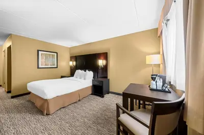 a hotel room with a large bed and a desk at Best Western Plus Mariposa Inn & Conference Centre in Orillia