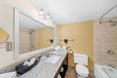 a bathroom with a sink and a toilet and a mirror at Best Western Plus Mariposa Inn & Conference Centre in Orillia