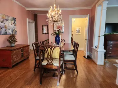a dining room with a table and chairs at Stone Carriage House in Picton