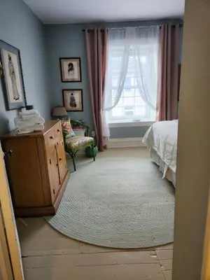 a bedroom with a bed and a window at Stone Carriage House in Picton