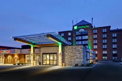 a hotel building with a sign on top of it at Holiday Inn - Mississauga Toronto West by IHG in Mississauga