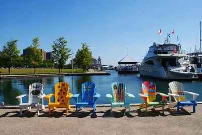 a group of chairs sitting in front of a boat at Holiday Inn & Suites Oakville at Bronte by IHG in Oakville