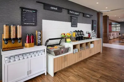 a restaurant with a counter with aasteryasteryasteryasteryasteryasteryasteryasteryastery at Holiday Inn & Suites Oakville at Bronte by IHG in Oakville