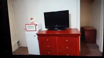 a television on top of a dresser with a microwave at Star Inn by Elevate Rooms in Niagara Falls