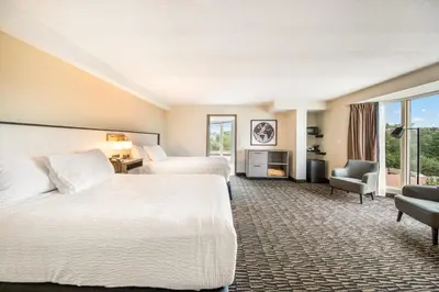 a hotel room with two beds and a window at Ramada Plaza by Wyndham Niagara Falls in Niagara Falls