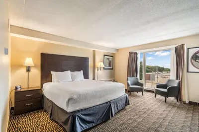 a hotel room with a bed and a window at Ramada Plaza by Wyndham Niagara Falls in Niagara Falls