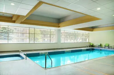 a pool in a building with a swimming pool at Allure Hotel & Conference Center in Barrie