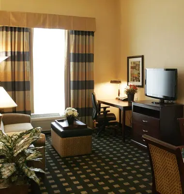 a hotel room with a desk and a television at Homewood Suites by Hilton Toronto Airport Corporate Centre in Toronto