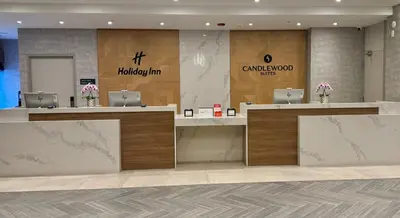 a lobby with two reception desks and two laptops at Holiday Inn Burlington Conference Centre by IHG in Burlington