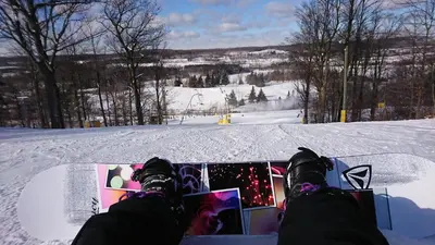 a person sitting on a snowboard in the snow at Holiday Inn Burlington Conference Centre by IHG in Burlington