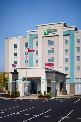 an image of a hotel with flags in a parking lot at Holiday Inn Express & Suites Kitchener Southeast by IHG in Kitchener