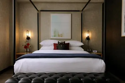 a bedroom with a large bed with a black canopy at The Anndore House, part of JDV by Hyatt in Toronto