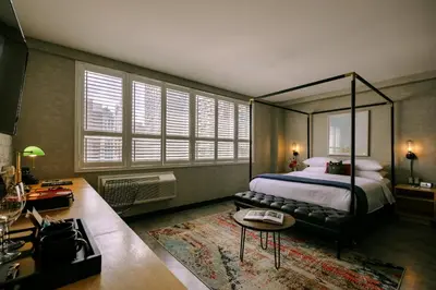 a bedroom with a canopy bed and a table at The Anndore House, part of JDV by Hyatt in Toronto