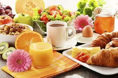 a table with a breakfast of fruit and juice at Admiral Inn Mississauga in Mississauga