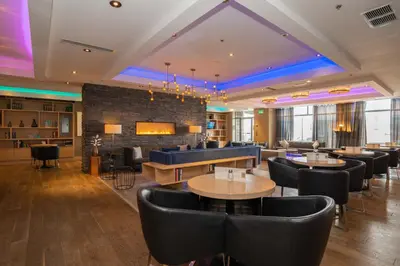 a restaurant with tables and chairs and a brick wall at Sandman Signature Mississauga Hotel in Mississauga