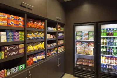 a grocery store store aisle with shelves of food and drinks at Cambridge Suites Mississauga in Mississauga