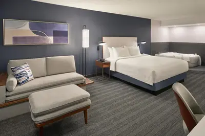 a hotel room with a bed and a couch at Courtyard by Marriott Toronto Mississauga/Meadowvale in Mississauga