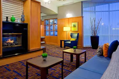 a living room with a couch and a fireplace at Courtyard by Marriott Toronto Mississauga/Meadowvale in Mississauga