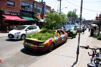 a car parked on the side of a city street at The Alexandra Hotel in Toronto