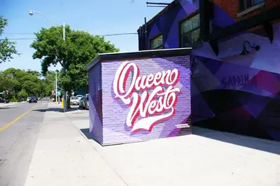 a purple wall with a sign that says omega mexico at The Alexandra Hotel in Toronto
