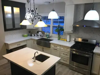 a kitchen with a sink and a stove at WHITE SWAN House in Niagara Falls