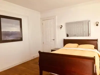 a bedroom with a bed and a picture on the wall at WHITE SWAN House in Niagara Falls