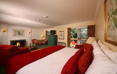 a bedroom with a large bed and a fireplace at Briars Resort and Spa in Georgina