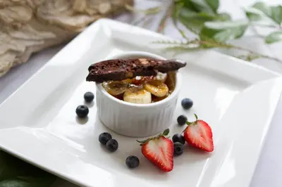 a dessert on a white plate with strawberries and blueberries at Briars Resort and Spa in Georgina