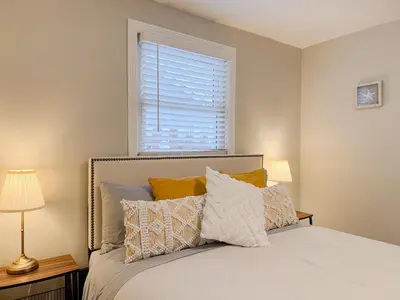 a bedroom with a bed with pillows and a window at Addison House License# 004-2025 in Niagara on the Lake