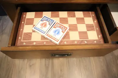 a wooden chess board in a wooden box with two cards at Addison House License# 004-2025 in Niagara on the Lake